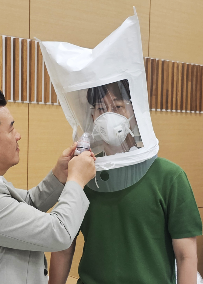 에너지경제신문 박규빈 기자가 3M의 안면 부여과식 방진 마스크 8977K를 착용한 후 비말 기밀성 테스트를 진행하는 모습.