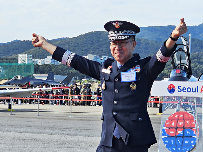 서울 국제 항공우주 및 방위산업 전시회(ADEX) 2025 현장에서 개회사를 전하고 단상에서 내려온 손석락 공군참모총장이 손가락 하트를 들어보이고 있다.
