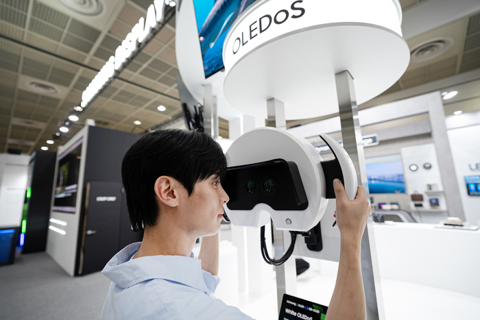 관람객이 삼성디스플레이가 'K-디스플레이 2025'에서 선보인 1.3형 4000PPI 해상도의 양안 화이트(W) 올레도스 제품을 체험해보고 있다.