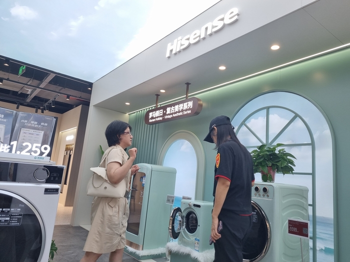중국 베이징에 위치한 가전 매장에서 한 소비자가 직원으로부터 하이센스 세탁기에 대한 설명을 듣고 있다. 사진 = 김윤호 기자.