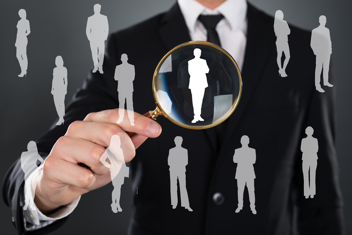 Businessman Searching Candidate With Magnifier