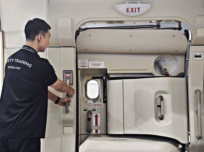 대한항공 객실 훈련원에서 비상구 출입문 작동법을 시연하는 교관. 사진=박규빈 기자