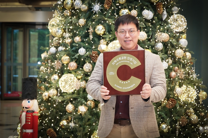 LG유플러스 직원이 지연사회공헌 인정 기관 상패를 소개하는 모습.