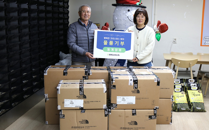 인천도시가스 이상규 상무이사(좌측)가 신명보육원 권옥희 사무국장에게 동계점퍼를 전달한 뒤 기념촬영을 하고 있다. (사진=인천도시가스)