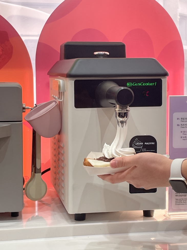 DIY존에 마련된 휘핑크림 디스펜서를 통해  구매한 빵을 커스터마이징하는 모습. 사진=조히니 기자