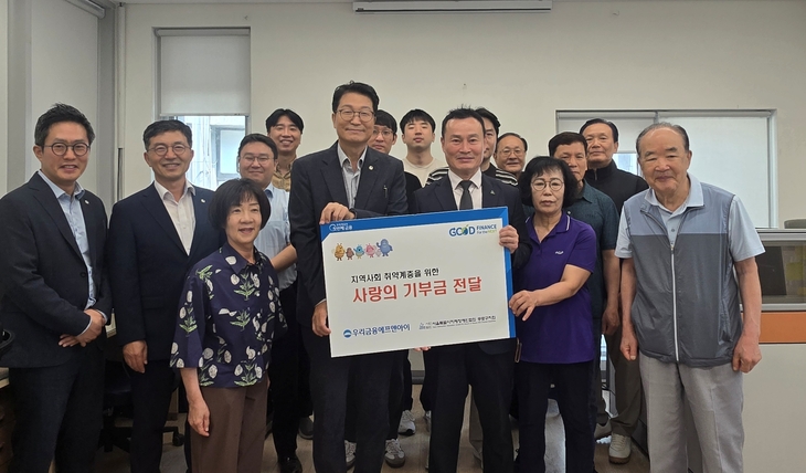 (2열 왼쪽 네번째부터) 김건호 우리금융에프앤아이 대표이사와 위성봉 서울시지체장애인협회 종로구지회장이 임직원들과 함께 지난달 30일 서울 종로
